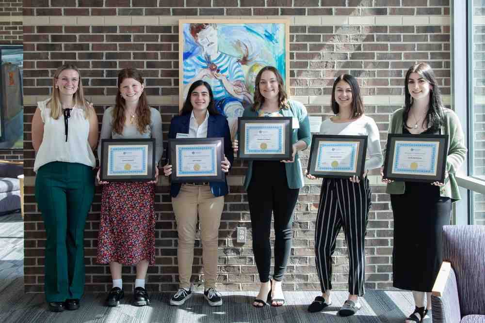 2024 PSY Award Ceremony recipients posing with frames